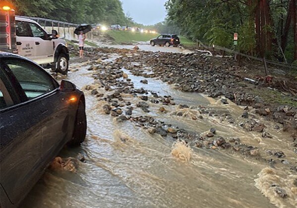 Vehicles come to a standstill near a washed-out and flooded portion of the Palisades Parkway just beyond the traffic circle off the Bear Mountain Bridge, Sunday, July 9, 2023, in Orange County, N.Y. Heavy rain spawned extreme flooding in New York’s Hudson Valley that killed at least one person, swamped roadways and forced road closures on Sunday night, as much of the rest of the Northeast U.S. geared up for a major storm. (AP Photo/David Bauder)