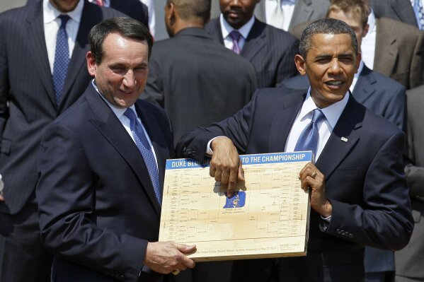 
              FILE - In this May 27, 2010 file photo, President Barack Obama looks over the bracket with Duke University basketball Coach Mike Krzyzewski in the Rose Garden of the White House in Washington, where he honored the team. From his campaign fist bump to his theatrical mic drop at the last White House correspondents’ dinner, Barack Obama ruled as America’s pop culture president. His two terms played out like a running chronicle of the trends of our times: slow-jamming the news with Jimmy Fallon, reading mean tweets with Jimmy Kimmel, filling out his NCAA basketball bracket on ESPN, cruising with Jerry Seinfeld on “Comedians in Cars Getting Coffee.” (AP Photo/Alex Brandon, File)
            