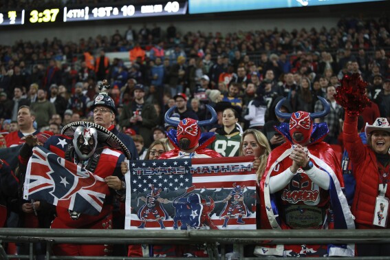 FILE - In this Sunday, Nov. 3, 2019 file photo, NFL fans watch teams play between the Houston Texans and the Jacksonville Jaguars during the second half of an NFL football game at Wembley Stadium, in London. The NFL has added games in Germany and has its eye on Spain. So it’s easy to overlook old standby Britain. London has been hosting games since 2007 and league officials remain high on the U.K. even as it scouts the continent for future host cities. (AP Photo/Ian Walton, File)