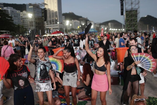 Fans cheer as they wait for the start of Lady Gaga's free concert on Copacabana beach in Rio de Janeiro, Saturday, May 3, 2025. (AP Photo/Bruna Prado)