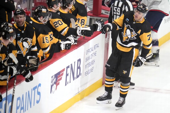 Pittsburgh Penguins' Evgeni Malkin (71) returns to the bench after after scoring against the Columbus Blue Jackets during the first period of an NHL hockey game in Pittsburgh, Tuesday, March 5, 2024. (AP Photo/Gene J. Puskar)