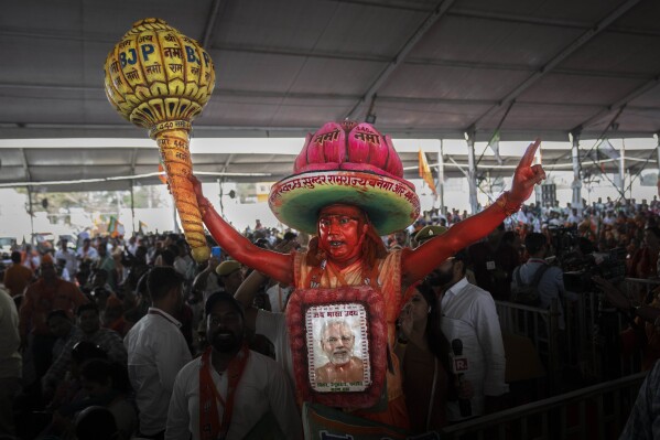 A supporter of India's ruling Bharatiya Janata Party (BJP) holds a mace, used as a weapon by Hindu god Hanuman, as he shouts slogans during an election campaign rally addressed by Indian Prime Minister Narendra Modi in Meerut, India, Sunday, March 31, 2024. (AP Photo/Altaf Qadri)