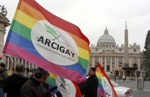 FILE - Italian Arcigay gay rights association activists hold banners and flags during a demonstration in front of The Vatican, in this Tuesday, Jan. 13, 2009 file photo. (AP Photo/Sandro Pace, file)