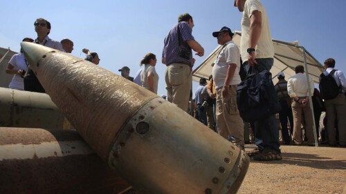 FILE - Activists and international delegations stand next to cluster bomb units, during a visit to a Lebanese military base at the opening of the Second Meeting of States Parties to the Convention on Cluster Munitions, in the southern town of Nabatiyeh, Lebanon, Sept. 12, 2011. The Biden administration has decided to provide cluster munitions to Ukraine and is expected to announce on Friday, July 6, 2023, that the Pentagon will send thousands as part of the latest military aid package for the war effort against Russia, according to people familiar with the decision. (AP Photo/Mohammed Zaatari, File)