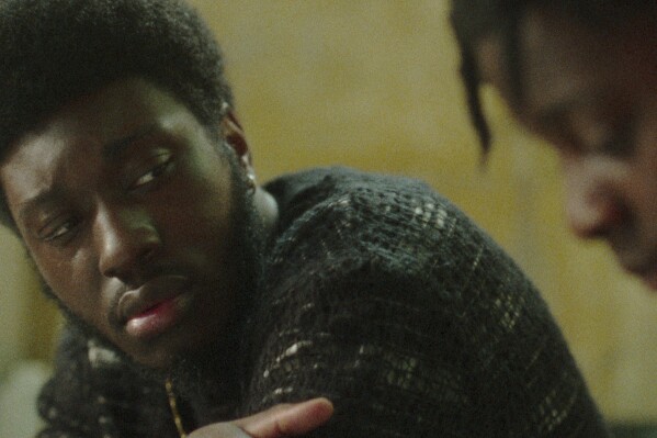 This image released by Netflix shows Hope Ikpoku Jnr, left, in a scene from 