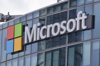FILE - This April 12, 2016 file photo shows the Microsoft logo in Issy-les-Moulineaux, outside Paris, France. Ongoing demand for Microsoft's cloud computing services help softened the blow of the c...