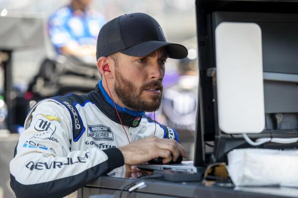 Ross Chastain looks at data on a computer during a NASCAR Xfinity Series auto race practice at Dover Motor Speedway, Saturday, April 30, 2022, in Dover, Del. (AP Photo/Jason Minto)