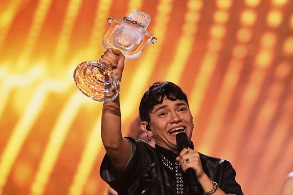 Winner of the Eurovision Song Contest JJ from Austria holds up the trophy onstage he won with the song 