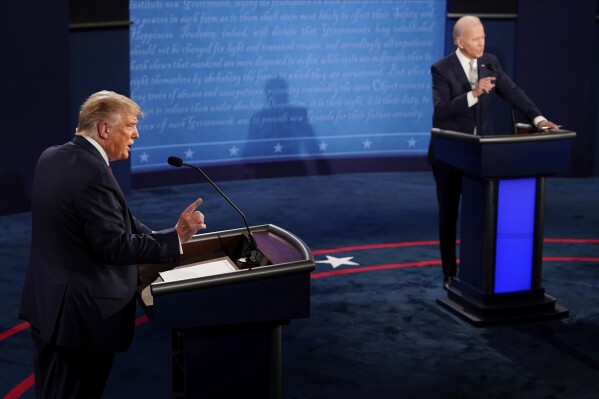 FILE - President Donald Trump and Democratic presidential candidate former Vice President Joe Biden exchange points during the first presidential debate Sept. 29, 2020, at Case Western University and Cleveland Clinic, in Cleveland, Ohio. President Joe Biden and former President Donald Trump have officially secured the requisite numbers of delegates to be considered their parties’ presumptive nominees. The designation allows the candidates to coordinate directly with the national Democratic and Republican parties, although they aren't considered official nominees until the summer conventions.(AP Photo/Morry Gash, Pool, File)