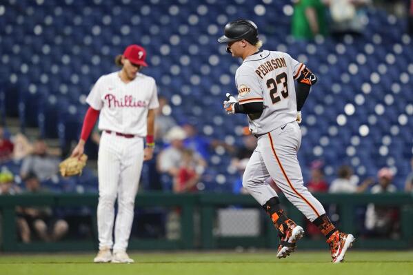 San Francisco Giants' Joc Pederson, right, rounds the bases past Philadelphia Phillies third baseman Alec Bohm after hitting a two-run home run during the 11th inning of a baseball game, Tuesday, May 31, 2022, in Philadelphia. (AP Photo/Matt Slocum)