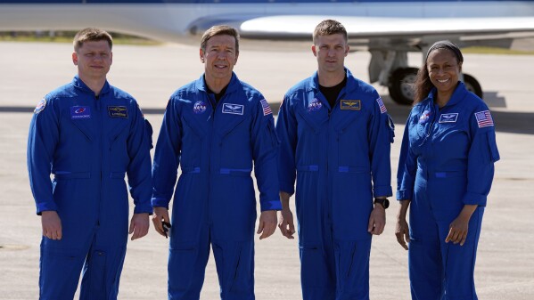 The SpaceX crew of the Dragon spacecraft, from left, cosmonaut Alexander Grebenkin, pilot Michael Barratt, commander Matthew Dominick and mission specialist Jeanette Epps gather for a photo after arriving at the Kennedy Space Center in Cape Canaveral, Fla., Sunday, Feb. 25, 2024. The launch with the crew to the International Space Station is scheduled for early Friday. (AP Photo/John Raoux)
