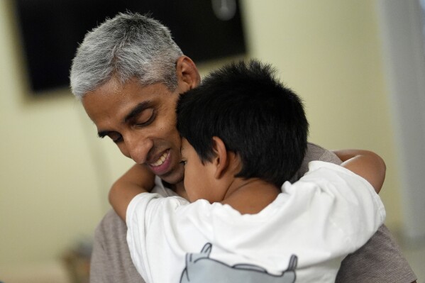 Politics tamfitronics Surgeon General Dr. Vivek Murthy hugs one of his children during a visit to his parents' home, Tuesday, July 16, 2024, near Miami, Fla. (AP Photo/Rebecca Blackwell)