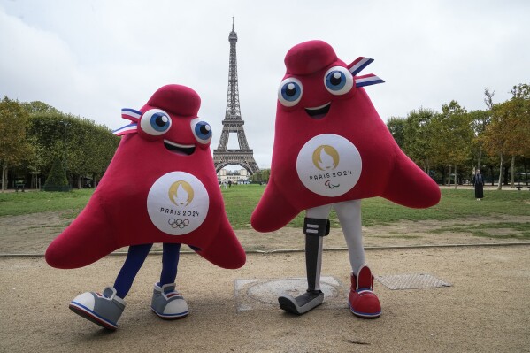 The mascots of the Paris 2024 Olympic, left, and Paralympic Games pose next to the Eiffel Tower in Paris, Monday, Aug. 28, 2023. Olympic and Paralympic organizers unveil plans and ambitions for next summer's Paralympic games in Paris that start just over two weeks after the Paris Olympic games end. (AP Photo/Michel Euler)