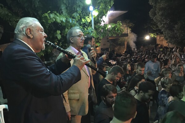 Petroloukas Chalkias, left, plays his clarinet as Antonis Kyritsis sings during a folk festival in Sklivani village, Epirus region, northwestern Greece, Thursday, Aug. 15, 2019. (AP Photo/Thanassis Stavrakis)