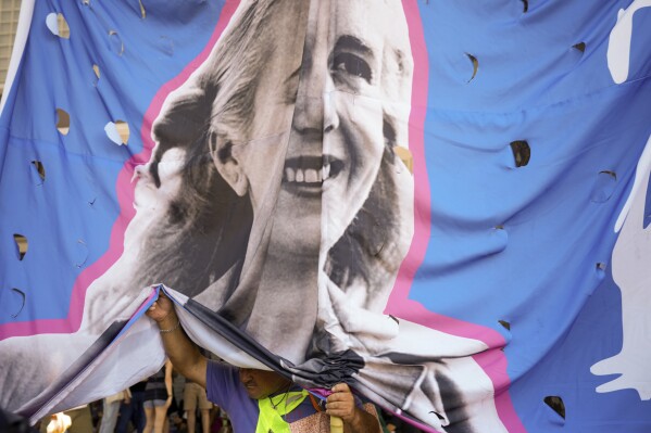 A demonstrator holds a banner of the late first lady Eva Peron during a march to Congress as part of a national strike against economic and labor reforms proposed by Argentine President Javier Milei in Buenos Aires, Argentina, Wednesday, Jan. 24, 2024. (AP Photo/Natacha Pisarenko)