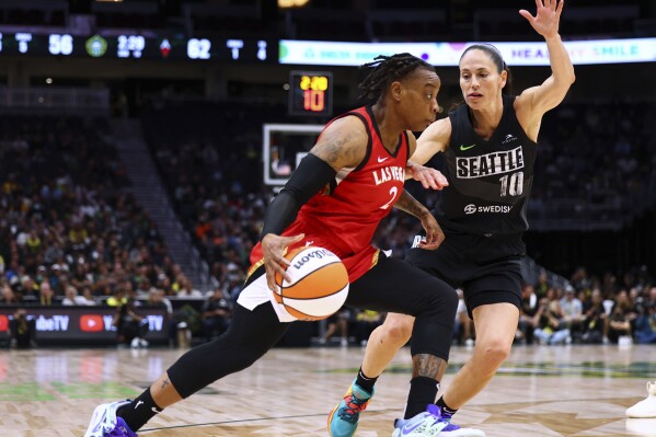FILE - Las Vegas Aces guard Riquna Williams (2) drives against Seattle Storm guard Sue Bird (10) during the second half of Game 4 of a WNBA basketball playoffs semifinal Tuesday, Sept. 6, 2022, in Seattle. Las Vegas Aces player Riquna Williams has been accused of felony domestic violence involving a person authorities say is her spouse. A judge on Wednesday, July 26, 2023, said the veteran shooting guard can be freed from jail without bail but can't contact her alleged victim pending another court appearance next week.(AP Photo/Lindsey Wasson, File)