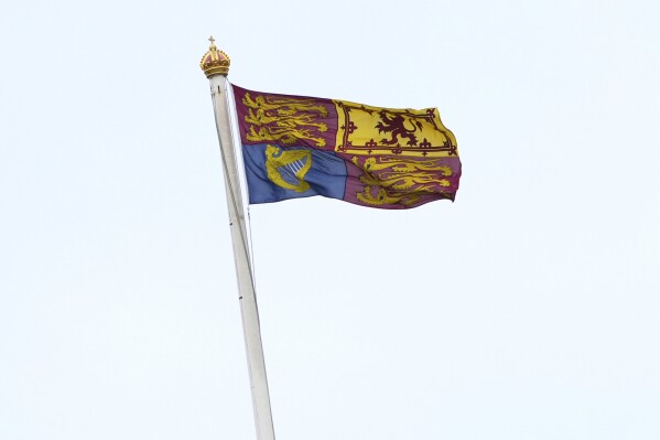The Royal Standard flag is pictured flying from the Roof of Buckingham Palace in London, Friday, March 28, 2025, after the Palace said King Charles III was hospitalized for observation on Thursday, experiencing "temporary side effects,'' related to a scheduled cancer treatment. (AP Photo/Kirsty Wigglesworth)