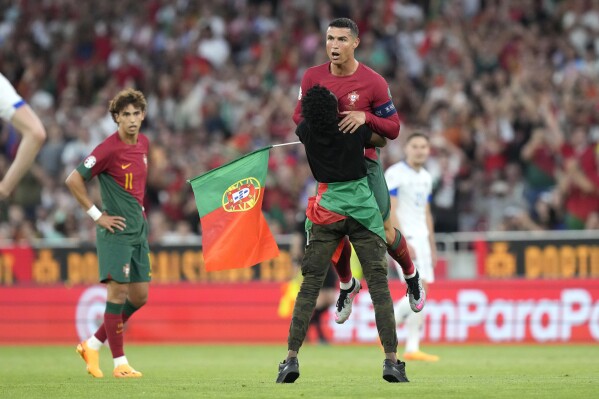 Ronaldo hugged and Fernandes scores 2 as Portugal wins Euro qualifier | AP  News