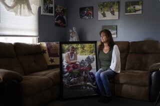 Karen Goodwin holds a photograph of her son, Austin Hunter Turner, in Bristol, Tenn. Turner died in 2017, at the age of 23, after an encounter with the Bristol Police Department. (AP Photo/George Walker IV)