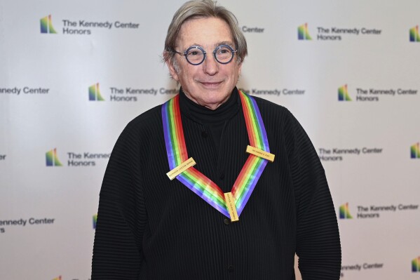 FILE - Conductor Michael Tilson Thomas arrives at the State Department for the Kennedy Center Honors gala dinner, Saturday, Dec. 3, 2022, in Washington. Tilson Thomas, an honoree in 2019, is to conduct the opening subscription program of the New York Philharmonic season. (AP Photo/Kevin Wolf, File)