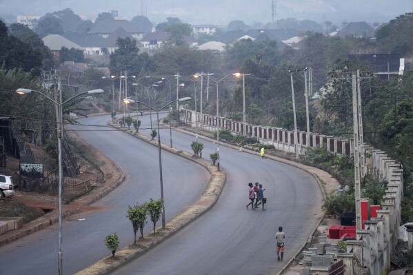 FILE - People walk across a normally packed highway during a separatists imposed lockdown in Enugu, Nigeria, Monday Feb. 14, 2022. Militants enforcing a separatist lockdown in Nigeria’s southeastern region attacked security forces deployed to restore order, killing five soldiers and six civilians during a shootout, the Nigerian military said Friday, May 31, 2024. (AP Photo/Jerome Delay, File)