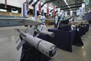 FILE - Iran's domestically built drones and weapons are displayed in an exhibition in a military compound belonging to the Defense Ministry, in Tehran, Iran, Aug. 23, 2023. The U.S. has imposed sanctions on seven people and four companies in China, Russia and Turkey who officials allege are connected with the development of Iran’s drone program. (AP Photo/Vahid Salemi, File)