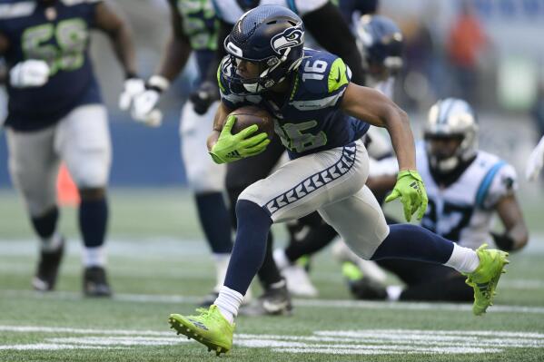 Seattle Seahawks wide receiver Tyler Lockett (16) runs against the Carolina Panthers during the first half of an NFL football game, Sunday, Dec. 11, 2022, in Seattle. (AP Photo/Caean Couto)