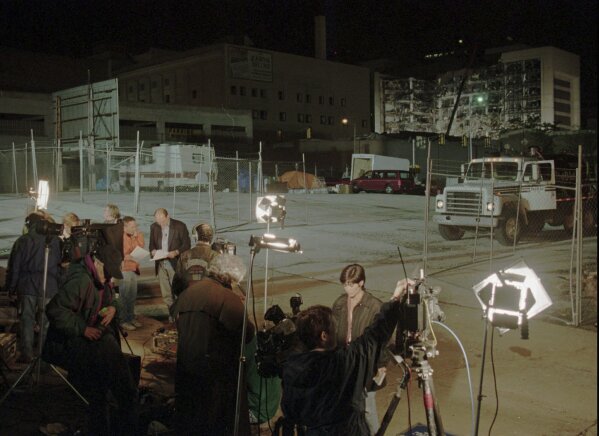 Television reporters report from the bombed Alfred P. Murrah Federal Building, back right, on April 20, 1995, in Oklahoma City. (AP Photo/Pat Sullivan, File)