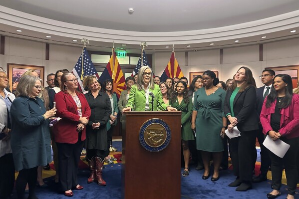 FILE - Arizona Gov. Katie Hobbs celebrates passages of abortion ballot measure surrounded by Democratic lawmakers and advocates on Nov. 25, 2024, at the State Capitol in Phoenix. (AP Photo/Sejal Govindarao, file)
