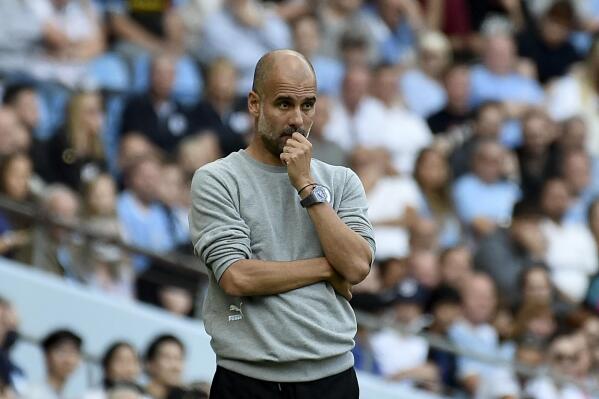 Manchester City's head coach Pep Guardiola watches during the English Premier League soccer match between Manchester City and Southampton at the Etihad Stadium in Manchester, England, Saturday, Sept. 18, 2021. (AP Photo/Rui Vieira)