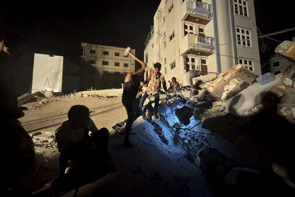 Rescuers work to find survivors in a house that collapsed after an earthquake in Mandalay, Myanmar, Saturday, March 29, 2025. (AP Photo/Thein Zaw)