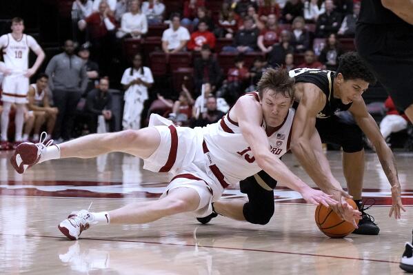 Stanford guard Michael Jones, left, vies for the ball against Colorado forward Tristan da Silva during the second half of an NCAA college basketball game Thursday, Dec. 29, 2022, in Stanford, Calif. (AP Photo/Tony Avelar)