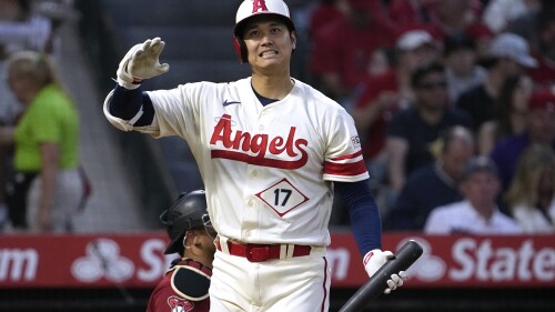 Los Angeles Angels' Shohei Ohtani grimaces after swinging for a strike during the fourth inning of a baseball game against the Arizona Diamondbacks Saturday, July 1, 2023, in Anaheim, Calif. (AP Photo/Mark J. Terrill)