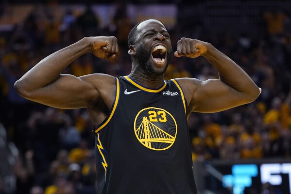 FILE - Golden State Warriors forward Draymond Green celebrates after scoring against the Dallas Mavericks during the second half in Game 5 of the NBA basketball playoffs Western Conference finals in San Francisco, May 26, 2022. Green has a sprained left ankle that will sideline him for at least the first two weeks of training camp. (AP Photo/Jeff Chiu, File)