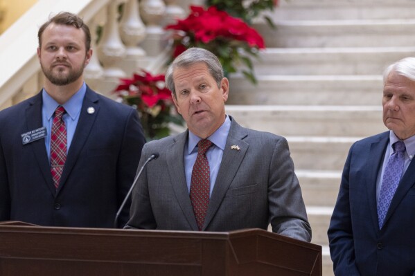 Gov. Brian Kemp speaks at a press conference at the Capitol in Atlanta on Monday, Dec. 18, 2023, announcing that he'll provide a $1,000 retention bonus to state employees, teachers and school support staff this holiday season. (Arvin Temkar/Atlanta Journal-Constitution via AP)