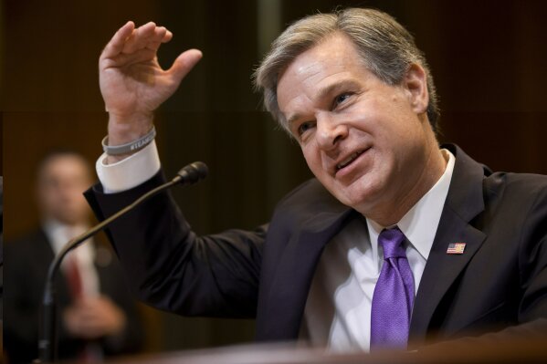 FILE - In this May 7, 2019, file photo, FBI Director Christopher Wray testifies during a hearing on Capitol Hill in Washington. Wray is set to appear before a Senate committee examining oversight of the bureau. The July 23 hearing could be something of a preview of the intense questioning special counsel Robert Mueller is likely to face when he appears before Congress the next day.  (AP Photo/Alex Brandon, File)