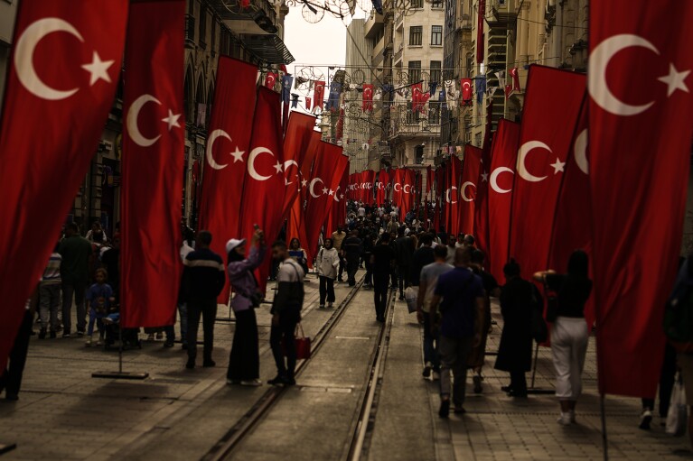 People walk along main Istiklal street in Istanbul, Thursday, Oct. 26, 2023. Turkey is marking its centennial but a brain drain is casting a shadow on the occasion. Government statistics indicate that a growing number of the young and educated are looking to move abroad in hopes of a better life, mainly in Europe. (AP Photo/Emrah Gurel)