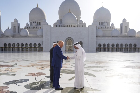 President Donald Trump shakes hands with with Yousif Al Obaidli, director of Sheikh Zayed Grand Mosque, during a tour of the Sheikh Zayed Grand Mosque, Thursday, May 15, 2025, in Abu Dhabi, United Arab Emirates. (AP Photo/Alex Brandon)