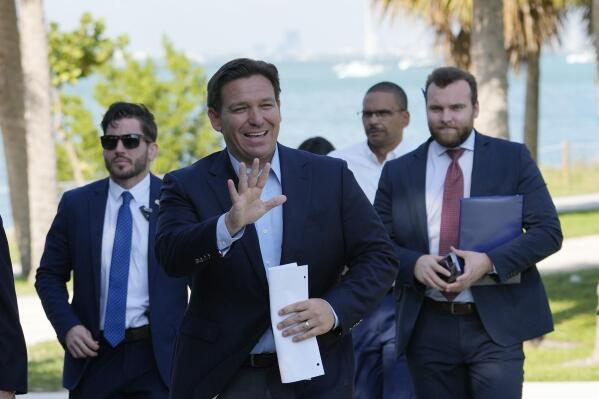 Florida Gov. Ron DeSantis waves as he arrives for a news conference at Bill Baggs Cape Florida State Park, Thursday, Dec. 1, 2022, on Key Biscayne, Fla. The Governor announced increased funding for the environmental protection of Biscayne Bay. (AP Photo/Lynne Sladky)