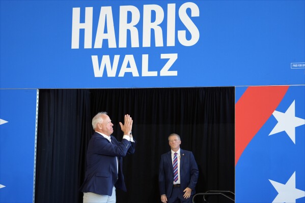 Democratic vice presidential candidate Minnesota Gov. Tim Walz arrives to speak at a campaign rally Wednesday, Aug. 7, 2024, in Romulus, Mich., before Democratic presidential nominee Vice President Kamala Harris. (AP Photo/Julia Nikhinson)