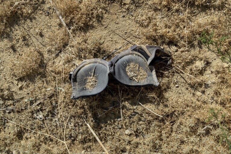 A woman's bra lies on the ground near the dried-up Aral Sea, outside Aralsk, Kazakhstan, Monday, July 3, 2023. (AP Photo/Ebrahim Noroozi)