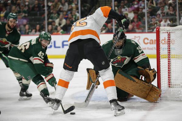 Minnesota Wild defenseman Jared Spurgeon (46) pokes the puck away form Philadelphia Flyers left wing James van Riemsdyk (25) with Minnesota Wild goaltender Marc-Andre Fleury (29) looks on in the second period of an NHL hockey game Tuesday, March 29, 2022, in St. Paul, Minn. (AP Photo/Andy Clayton-King)