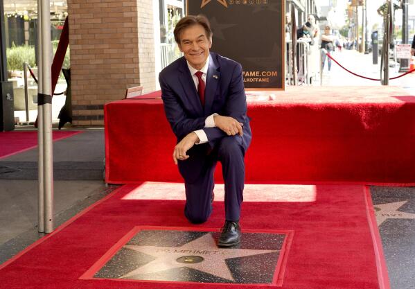 FILE - Mehmet Oz, the former host of "The Dr. Oz Show," poses atop his new star on the Hollywood Walk of Fame during a ceremony on Feb. 11, 2022, in Los Angeles. Oz may have made his reputation as a surgeon. But he made a fortune as a salesman on daytime TV. Now he is trying to leverage his celebrity as the Republican candidate in a bitterly contested U.S. Senate race in Pennsylvania. (AP Photo/Chris Pizzello, File)
