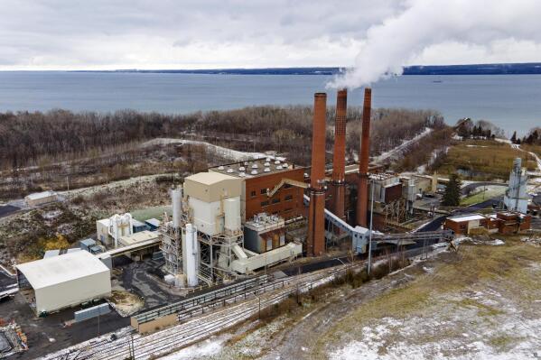 FILE - The Greenidge Generation bitcoin mining facility, in a former coal plant by Seneca Lake in Dresden, New York, is shown in this photo from Nov. 29, 2021. A milestone measure that would tap the brakes on the spread of cryptocurrency mining operations burning fossil fuels in New York has passed the state Legislature. The bill approved early Friday, June 3, 2022,  by the state Senate would establish a two-year moratorium on new and renewed air permits for fossil fuel power plants used for energy-intensive “proof-of-work” cryptomining. The plant also produces power for the state's electricity grid. (AP Photo/Ted Shaffrey, File)