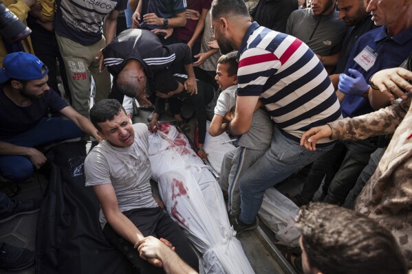 Palestinians react next to the bodies of their relatives who were killed in an Israeli airstrike in Gaza Stirp, at the Al Aqsa hospital in Deir al Balah, Gaza, Thursday, May 2, 2024. (AP Photo/Abdel Kareem Hana)
