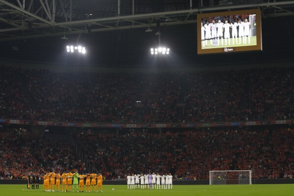 Squads observe a moment of silence for the victims of recent Hamas attack in Israel ahead of the Euro 2024 group B qualifying soccer match between The Netherlands and France at the Johan Cruyff ArenA stadium in Amsterdam, Netherlands, Friday, Oct. 13, 2023. (AP Photo/Peter Dejong)
