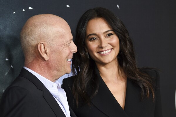 FILE - Actor Bruce Willis, left, and his wife Emma Heming Willis attend the premiere of "Glass" in New York on Jan. 15, 2019. Heming Willis is working on a guide to care giving that draws upon her experiences tending to her husband who has been diagnosed with frontotemporal dementia. The book, currently untitled, is scheduled for 2025. (Photo by Evan Agostini/Invision/AP, File)