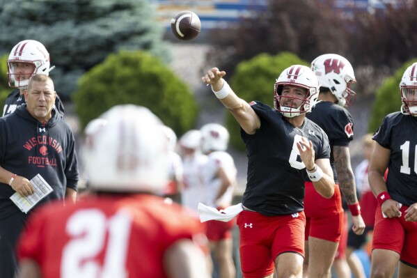 Wisconsin NCAA college football quarterback Tanner Mordecai (8) throws a pass on the first day of training camp in Platteville, Wisc., Wednesday, Aug. 2, 2023. (Samantha Madar/Wisconsin State Journal via AP)