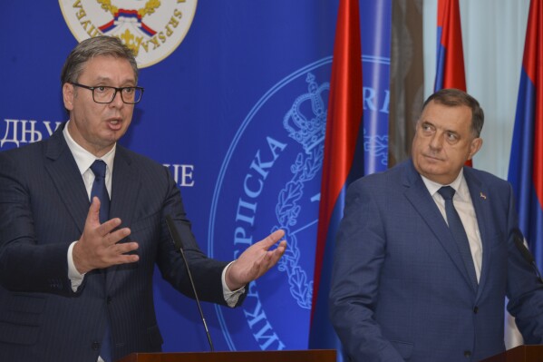 Serbian President Aleksandar Vucic, left, speaks during a press conferenca after talks with Bosnian Serb leader Milorad Dodik in Banja Luka, northern Bosnia, Friday, Aug. 4, 2023. Serbia will ignore U.S. sanctions recently imposed on top Bosnian Serb officials for undermining a 1995 peace agreement that ended a war that left more than 100,000 dead and millions homeless, the Serbian president said Friday. (AP Photo/Radivoje Pavicic)