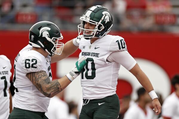 Michigan State quarterback Payton Thorne (10) celebrates a touchdown with Luke Campbell (62) during the first half of an NCAA college football game against Rutgers, Saturday, Oct. 9, 2021, in Piscataway, N.J. (AP Photo/Adam Hunger)